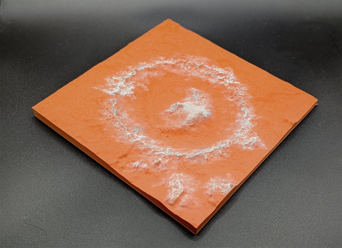 Orange 3D-printed Mars crater tile with a central peak and white-highlighted rim